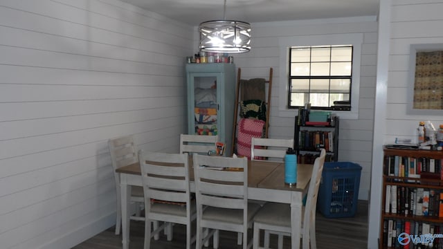 dining room with a notable chandelier and wood finished floors