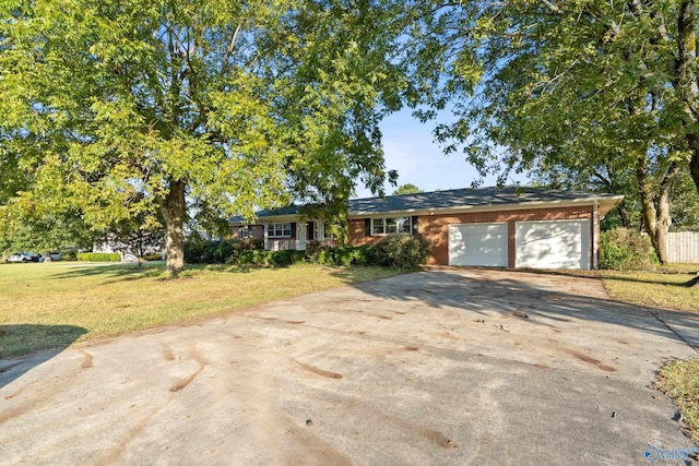 single story home featuring a garage and a front lawn