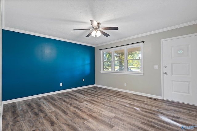 empty room with wood-type flooring, crown molding, and ceiling fan