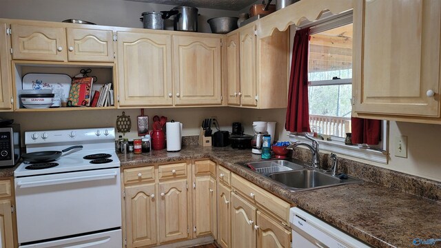 kitchen with light brown cabinets, white appliances, dark countertops, and a sink