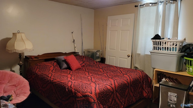 bedroom with a paneled ceiling