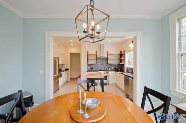 dining space featuring a wealth of natural light, crown molding, a notable chandelier, and recessed lighting