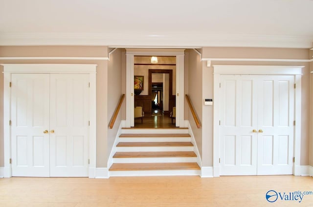 stairway featuring baseboards and wood finished floors