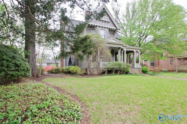 victorian-style house with a porch and a front yard