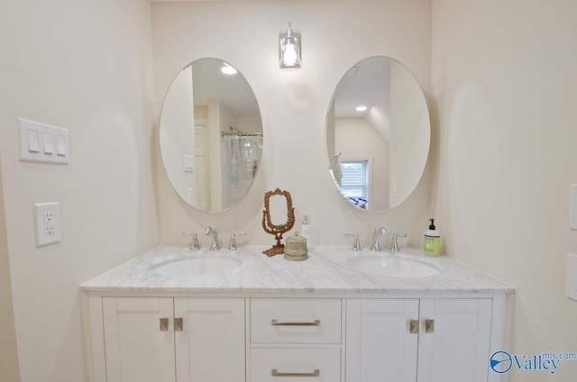 full bath with double vanity and a sink