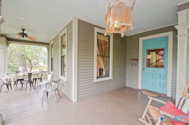 exterior space with a porch, outdoor dining area, and a ceiling fan