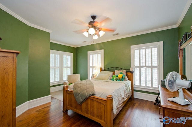 bedroom featuring crown molding, dark wood-type flooring, and baseboards