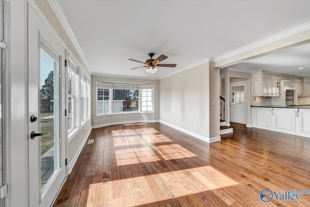 unfurnished sunroom with ceiling fan