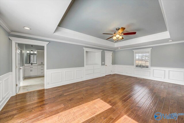 spare room featuring hardwood / wood-style flooring, ceiling fan, and a tray ceiling
