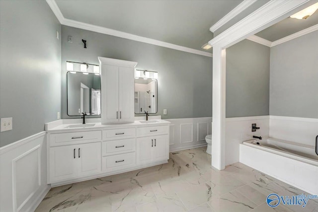 bathroom with a washtub, vanity, ornamental molding, and toilet