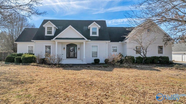 new england style home with a front yard