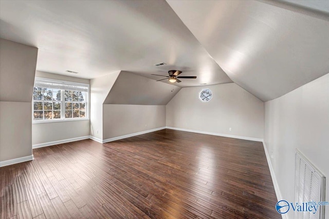 bonus room with dark hardwood / wood-style flooring, lofted ceiling, and ceiling fan