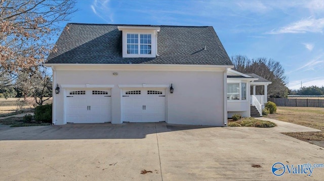 view of side of home featuring a garage