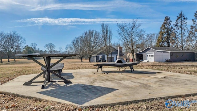 view of community with a patio area and a storage shed