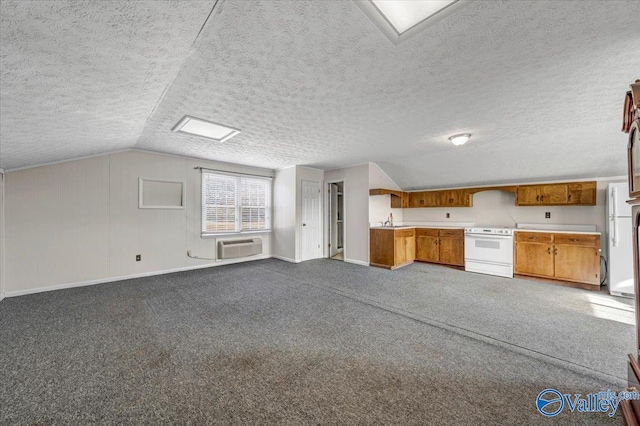 unfurnished living room with lofted ceiling, sink, carpet, a wall mounted air conditioner, and a textured ceiling