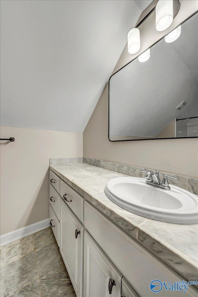 bathroom featuring vanity and vaulted ceiling
