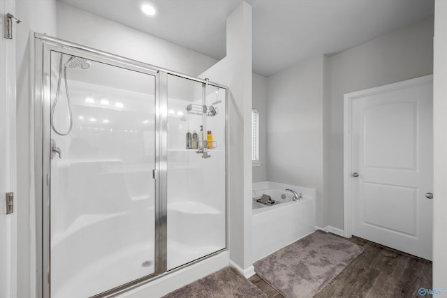 137 Sunlit Grove Dr, Harvest, AL 35749 - full bathroom with a bath, a shower stall, and wood finished floors