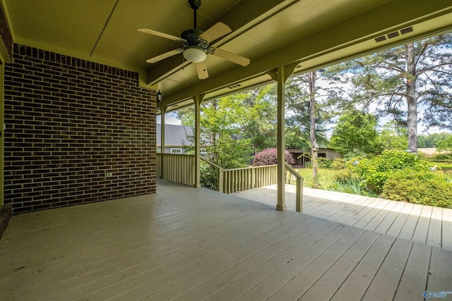 wooden deck featuring ceiling fan