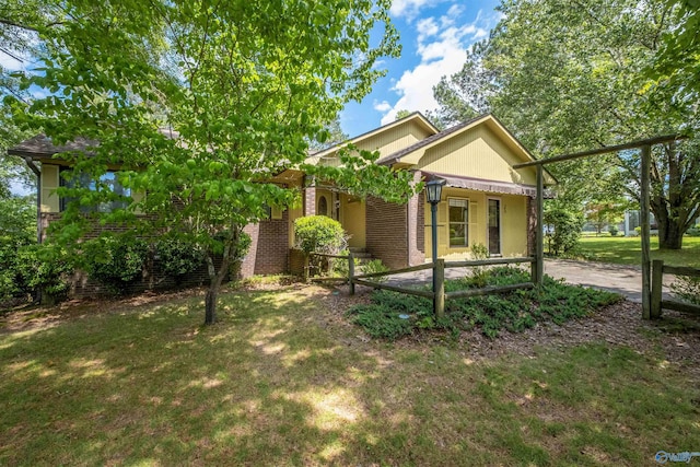 view of front of property with brick siding and a front lawn