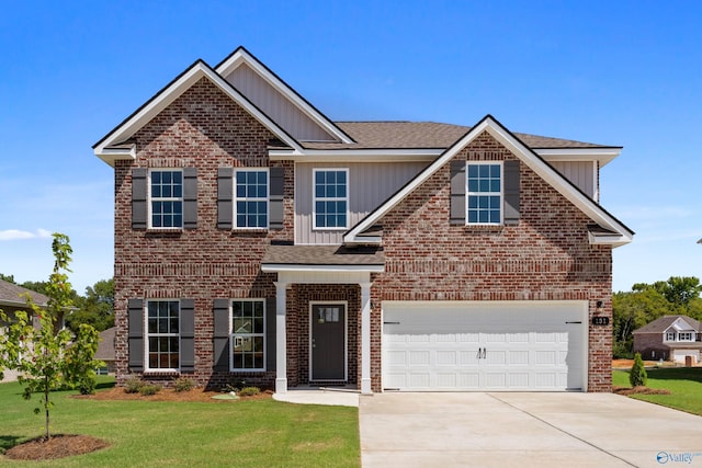 view of front of property featuring a garage and a front yard