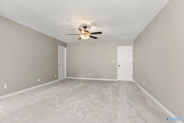 carpeted spare room with ceiling fan and a textured ceiling