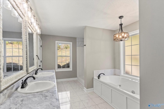 bathroom featuring a bathing tub, a notable chandelier, and vanity