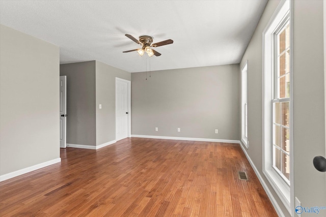 empty room featuring hardwood / wood-style floors, a textured ceiling, and ceiling fan