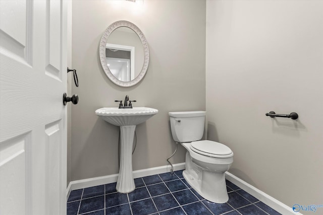 bathroom with toilet and tile patterned flooring