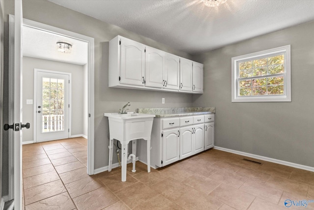 laundry area with a textured ceiling