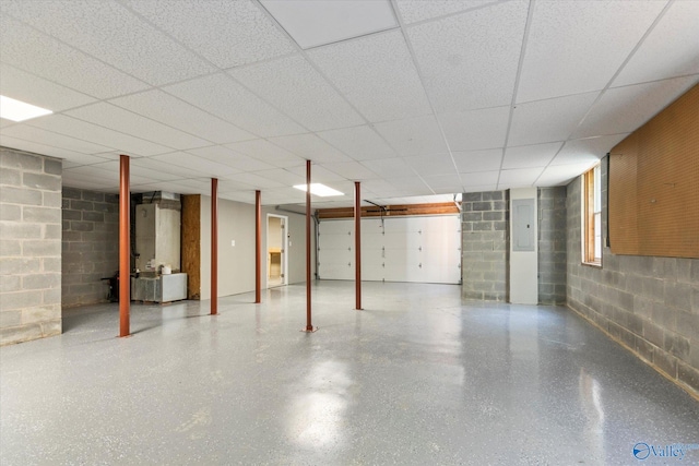 basement featuring electric panel and a drop ceiling