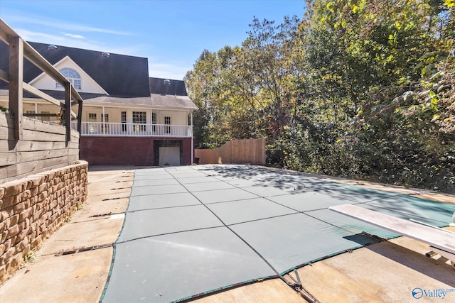 exterior space featuring a patio area, a covered pool, and a garage