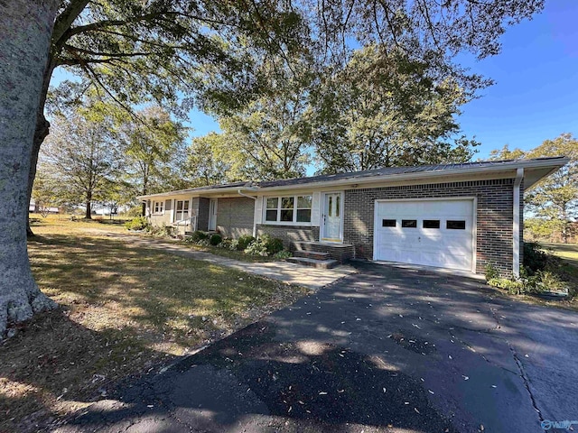 ranch-style home with a garage and a front lawn