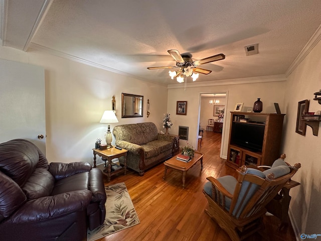 living room featuring crown molding, hardwood / wood-style flooring, a textured ceiling, and ceiling fan