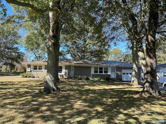 single story home with a front yard and a garage