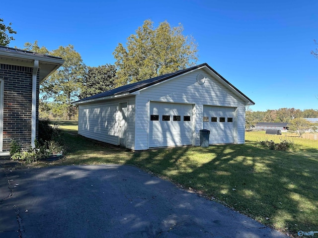 garage featuring a lawn