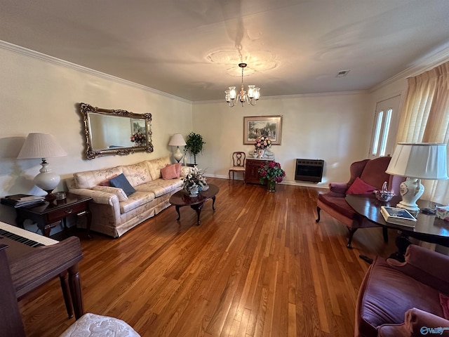 living room featuring hardwood / wood-style floors, crown molding, heating unit, and a chandelier