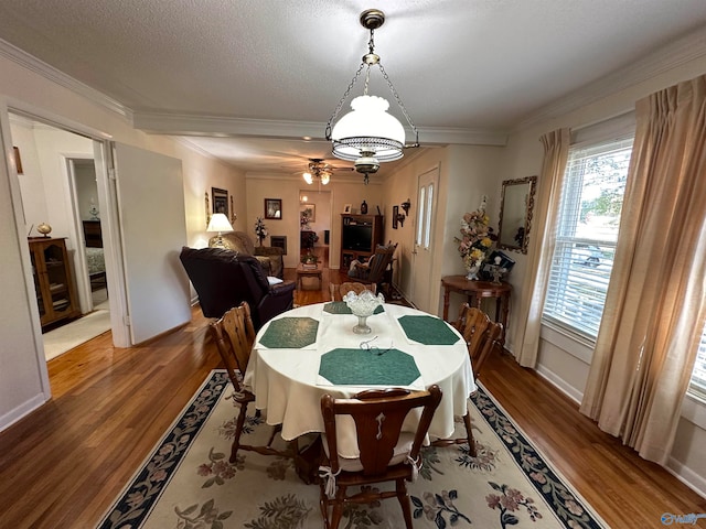 dining room featuring ornamental molding and wood-type flooring