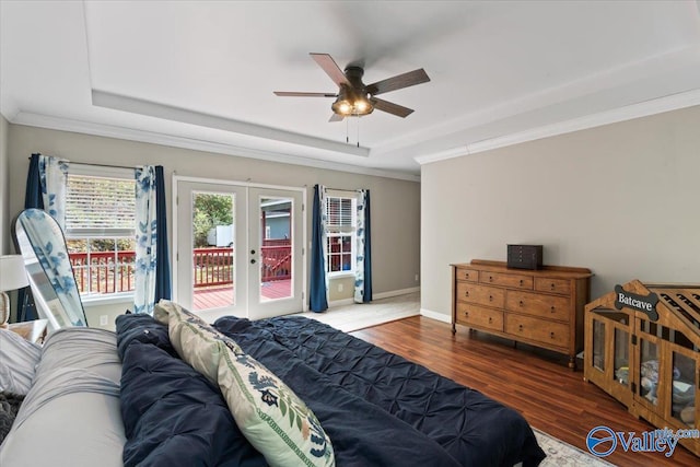 bedroom with french doors, access to outside, dark wood-type flooring, ceiling fan, and a tray ceiling