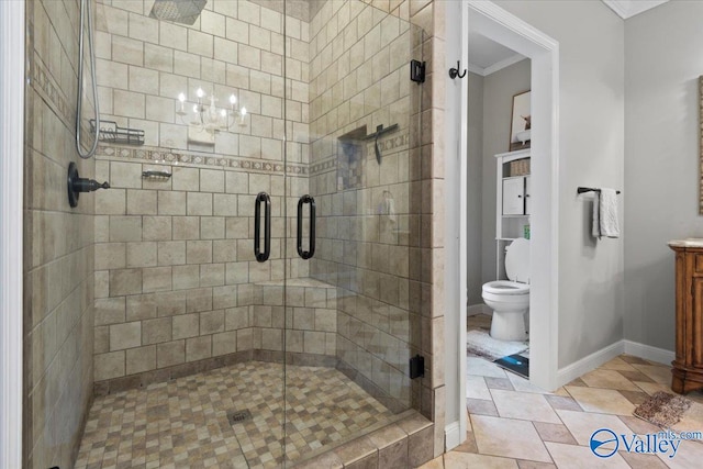 bathroom featuring toilet, vanity, a shower with door, and ornamental molding