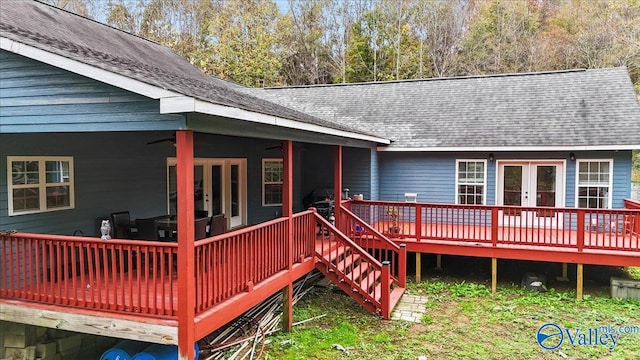 wooden deck with ceiling fan and french doors