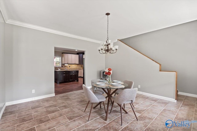 dining room featuring an inviting chandelier and ornamental molding