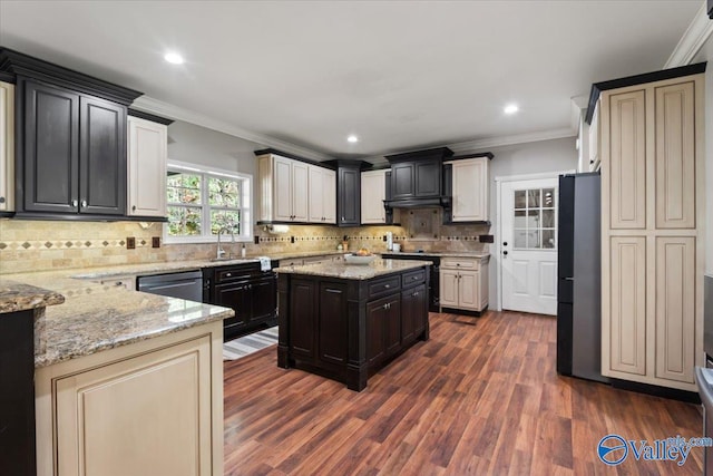 kitchen featuring dark hardwood / wood-style flooring, a kitchen island, light stone countertops, and ornamental molding