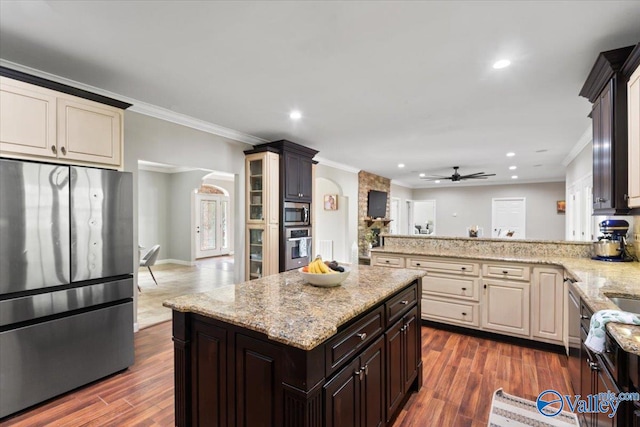 kitchen featuring ornamental molding, stainless steel appliances, ceiling fan, and dark hardwood / wood-style flooring