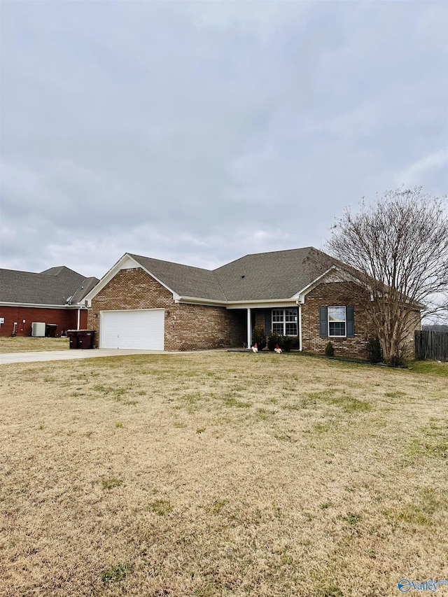 ranch-style house featuring a garage and a front lawn