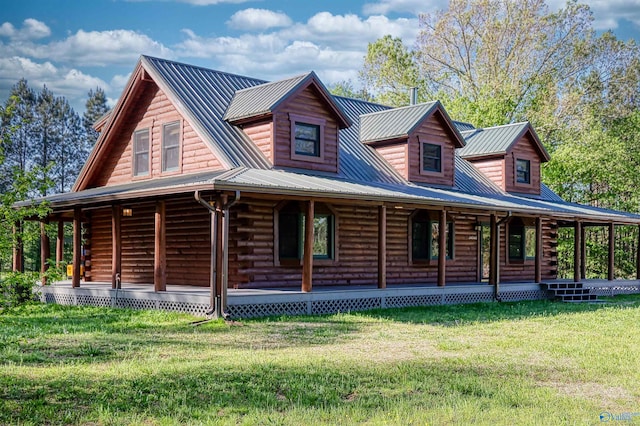 log home with covered porch and a front lawn