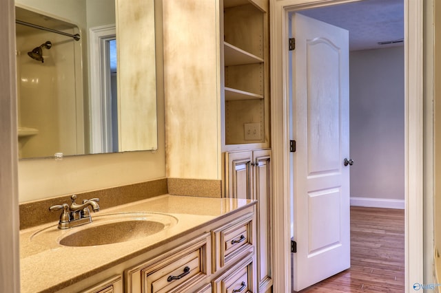 bathroom featuring vanity and hardwood / wood-style flooring