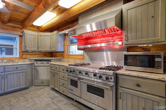 kitchen with appliances with stainless steel finishes, beamed ceiling, sink, wooden ceiling, and wall chimney exhaust hood