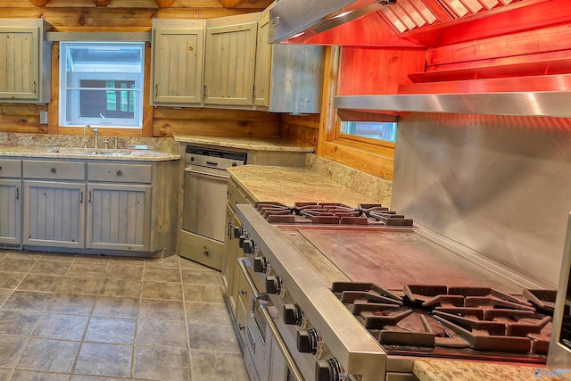 kitchen featuring sink, tile patterned flooring, and custom exhaust hood