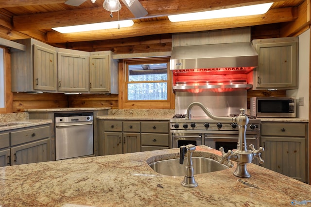 kitchen with beamed ceiling, appliances with stainless steel finishes, wooden ceiling, and wall chimney exhaust hood