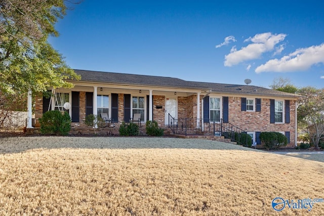 single story home featuring a front lawn and a porch